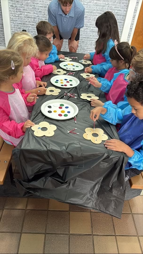 Children painting together at Frog Academy