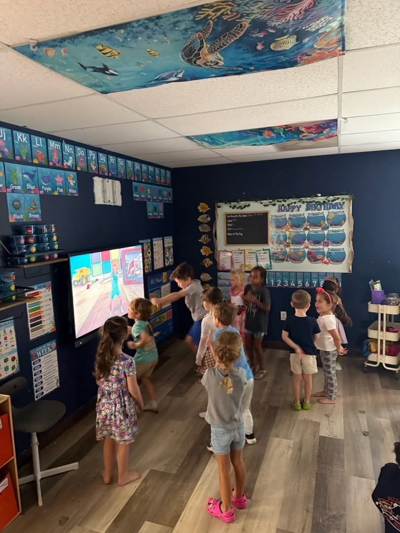 Children participating in a classroom movement activity